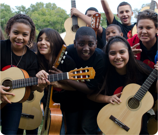 Group of Students with Acoustic Guitars A large group of students smiling at the camera holding acoustic guitars.