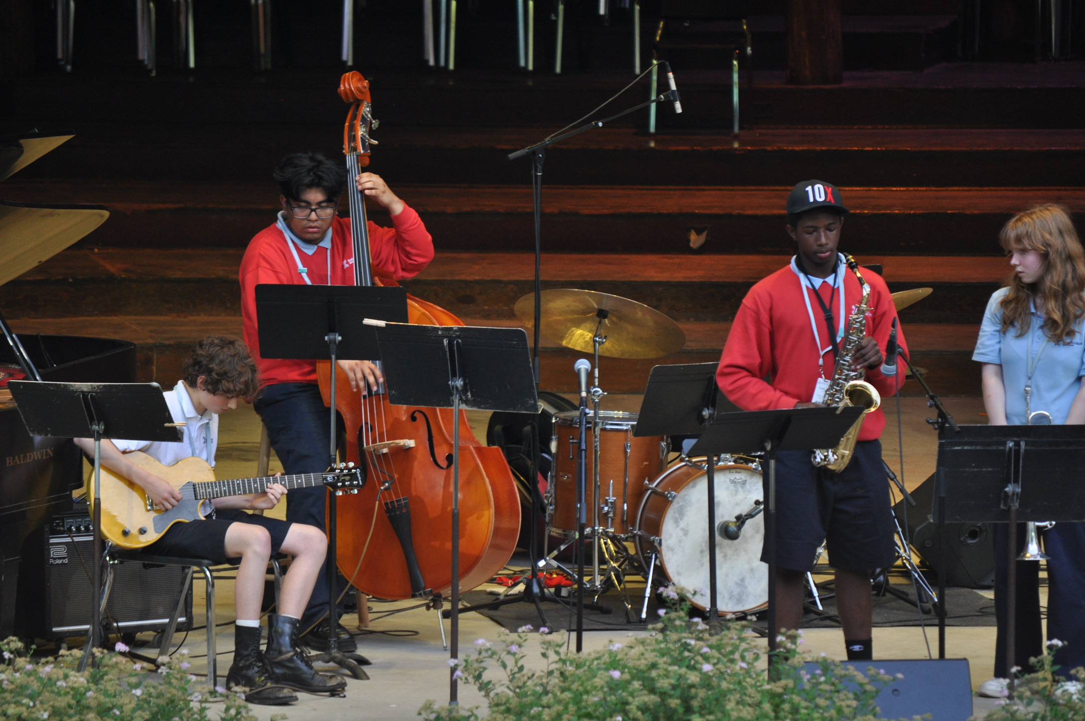 student playing bass on stage.