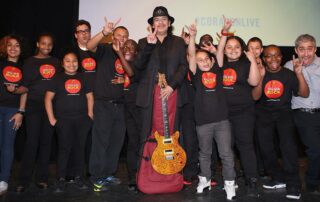American artist, Carlos Santana, with several Music Will students
