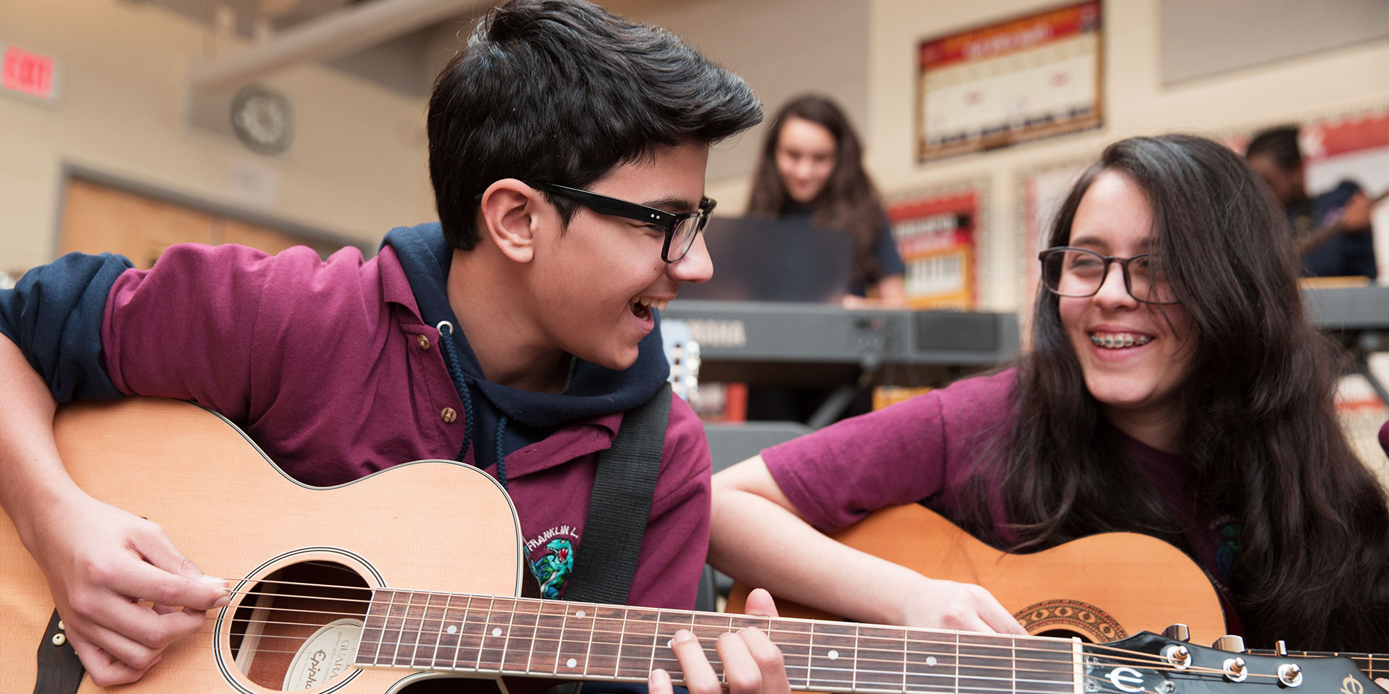 students-playing-guitar-together